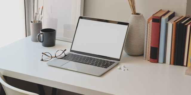photo of laptop near books