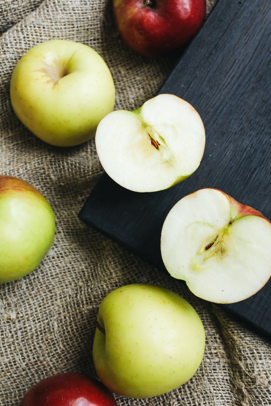 close up photo of sliced apples on wooden surface